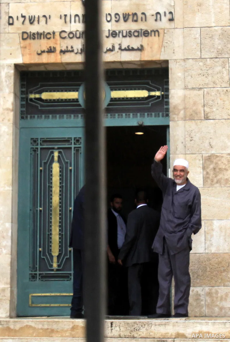 Leader of the radical northern wing of the Islamic Movement in Israel, Sheikh Raed Salah, gestures outside a Jerusalem court after he was convicted on October 27, 2015. An Israeli court upheld a conviction of the firebra...