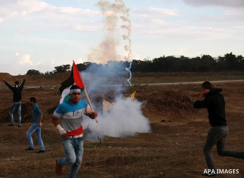 A Palestinian protester runs for cover during clashes with Israeli troops near the border between Israel and Central Gaza Strip October 27, 2015. The current round of violence began last month with clashes at Jerusalem's...