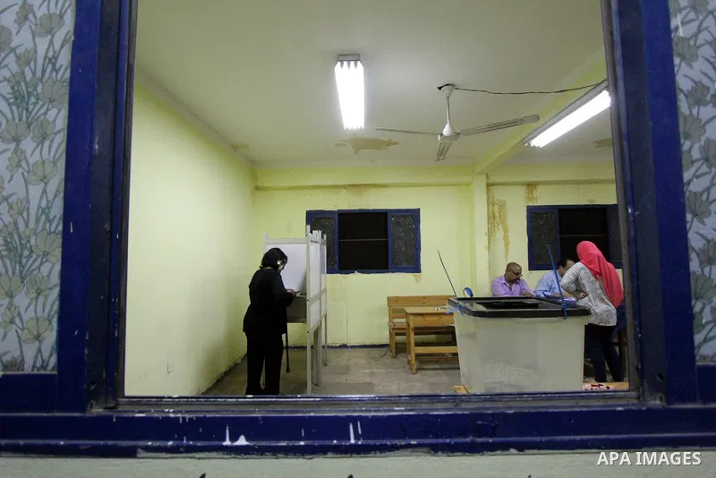 An Egyptian woman casts her ballot at a polling station in Cairo, as voters returned to polling stations on October 27, 2015 for a first round run-off in a parliamentary vote expected to elect lawmakers firmly backing Pr...