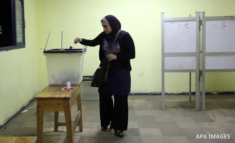 An Egyptian woman casts her ballot at a polling station in Cairo, as voters returned to polling stations on October 27, 2015 for a first round run-off in a parliamentary vote expected to elect lawmakers firmly backing Pr...