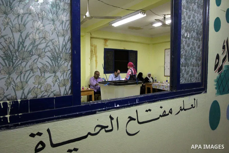 An Egyptian woman casts her ballot at a polling station in Cairo, as voters returned to polling stations on October 27, 2015 for a first round run-off in a parliamentary vote expected to elect lawmakers firmly backing Pr...