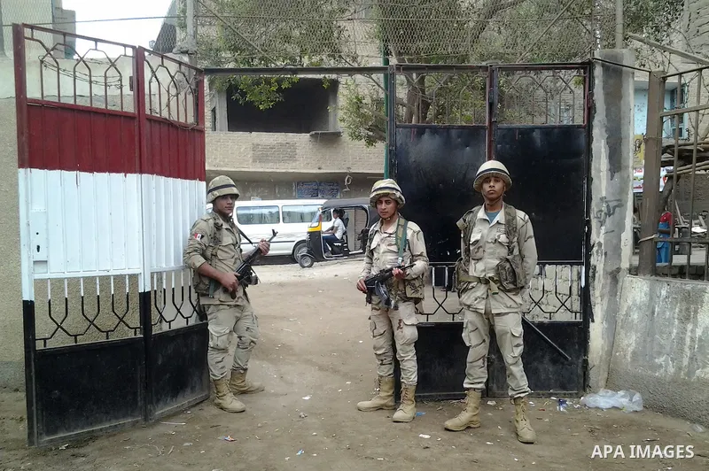 Egyptian soldiers stand guard at a polling station of the runoff to the first round of the parliamentary elections in Cairo, Egypt, Wednesday, Oct. 28, 2015. Photo by Amr Sayed