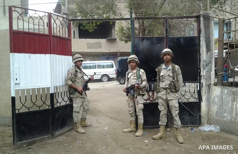 Egyptian soldiers stand guard at a polling station of the runoff to the first round of the parliamentary elections in Cairo, Egypt, Wednesday, Oct. 28, 2015. Photo by Amr Sayed