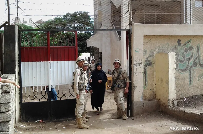 Egyptian soldiers stand guard at a polling station of the runoff to the first round of the parliamentary elections in Cairo, Egypt, Wednesday, Oct. 28, 2015. Photo by Amr Sayed