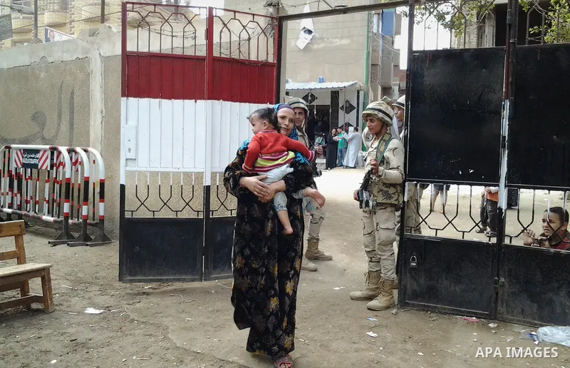 Egyptian soldiers stand guard at a polling station of the runoff to the first round of the parliamentary elections in Cairo, Egypt, Wednesday, Oct. 28, 2015. Photo by Amr Sayed