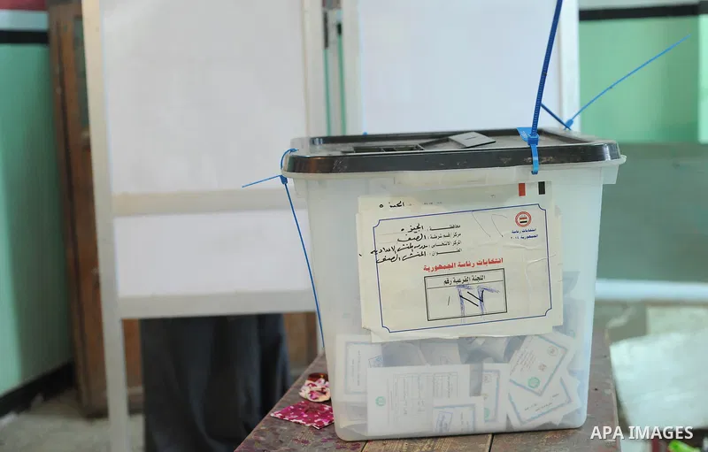 Egyptians cast their ballot at a polling station of the runoff to the first round of the parliamentary elections in Cairo, Egypt, Wednesday, Oct. 28, 2015. Photo by Amr Sayed