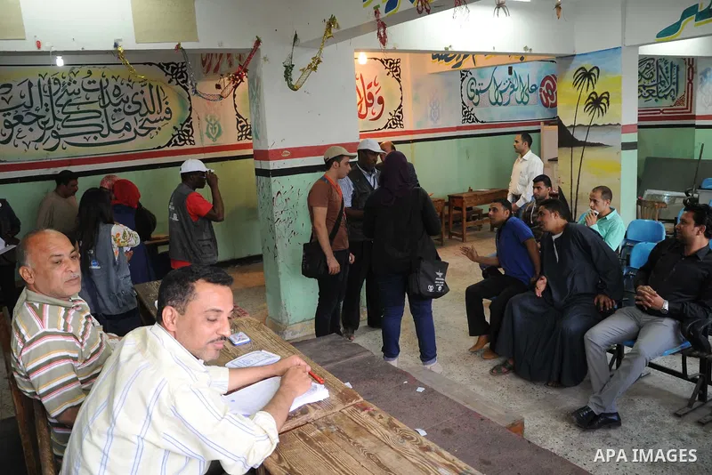 Egyptians cast their ballot at a polling station of the runoff to the first round of the parliamentary elections in Cairo, Egypt, Wednesday, Oct. 28, 2015. Photo by Amr Sayed