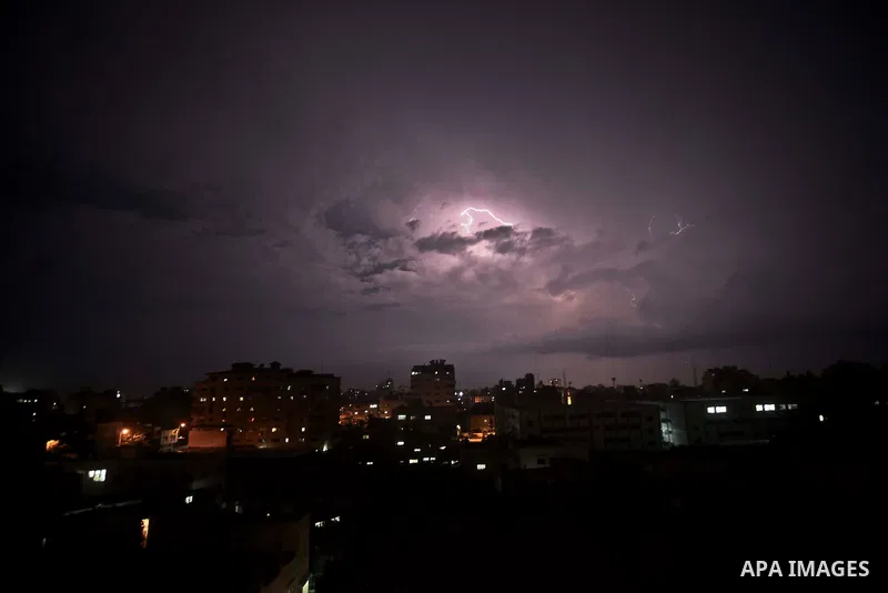 A picture taken on October 28, 2015 shows lighting striking during a storm in Gaza city. Photo by Mohammed Talatene