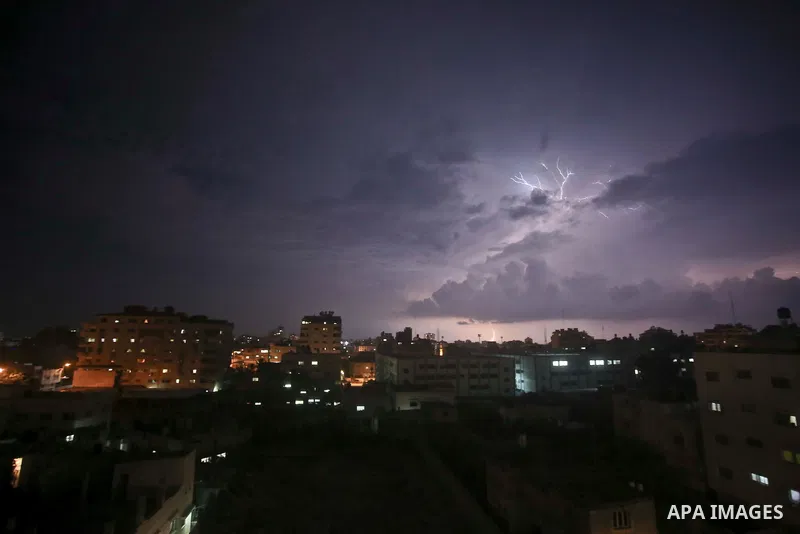 A picture taken on October 28, 2015 shows lighting striking during a storm in Gaza city. Photo by Mohammed Talatene