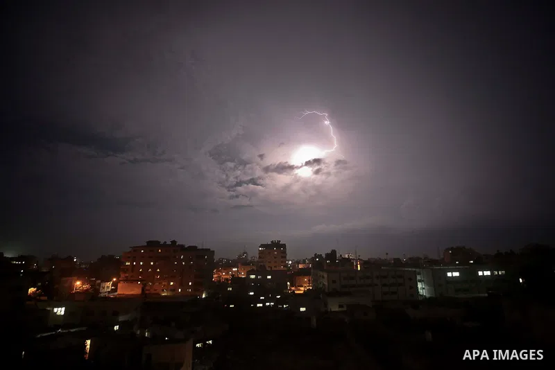 A picture taken on October 28, 2015 shows lighting striking during a storm in Gaza city. Photo by Mohammed Talatene
