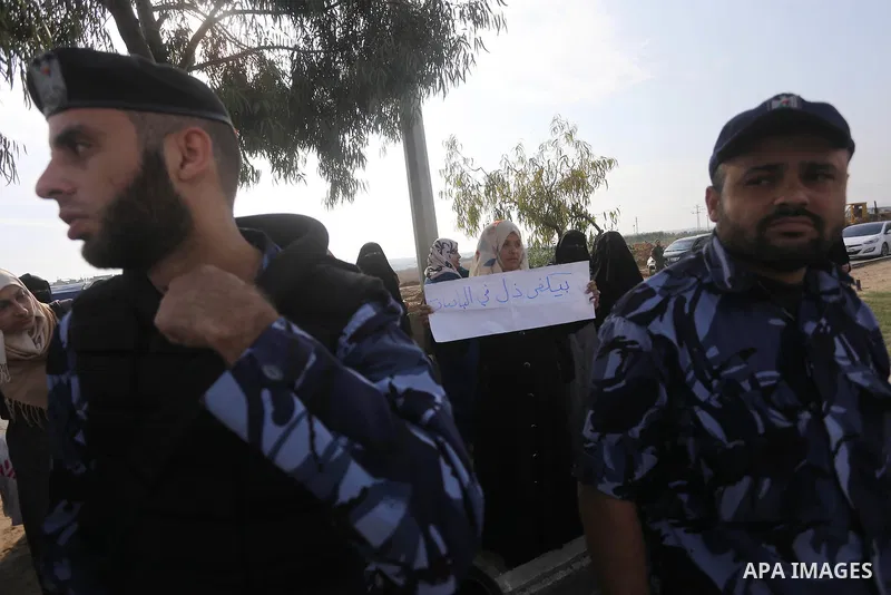 Palestinian teachers hold banners during a protest to demand their salaries, in Gaza City, on Oct. 29, 2015. Photo by Mohammed Asad