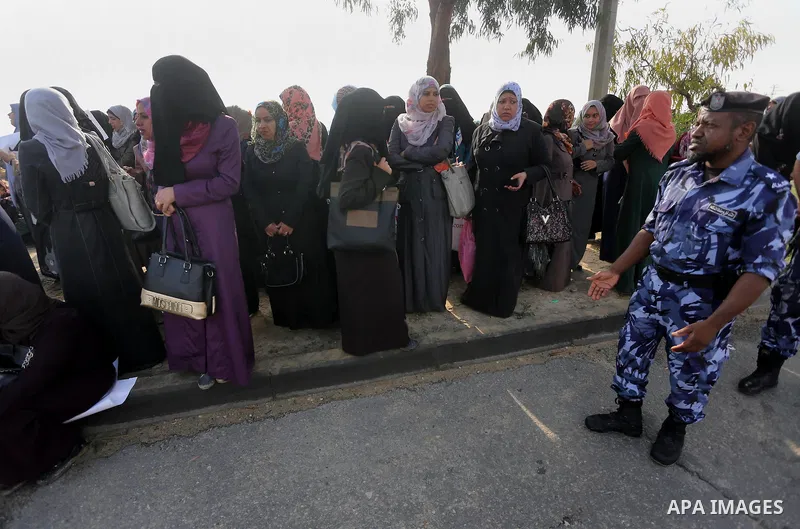 Palestinian teachers hold banners during a protest to demand their salaries, in Gaza City, on Oct. 29, 2015. Photo by Mohammed Asad
