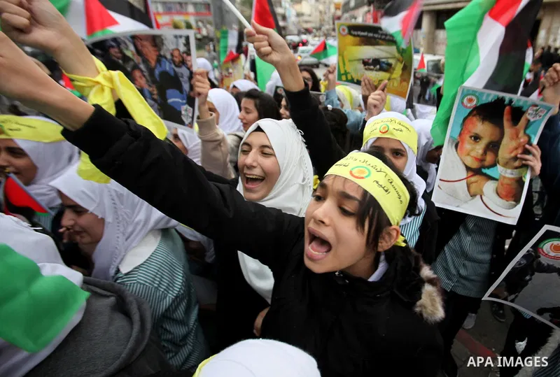 Palestinian students hold National flags during a protest to demand their rights, in the west Bank city of Nablus, on Oct. 29, 2015. Photo by Nedal Eshtayah