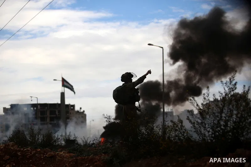 An Israeli soldier takes position during clashes with Palestinian protesters near the Jewish settlement of Bet El, near the West Bank city of Ramallah, October 29, 2015. Israeli security forces shot dead two Palestinian...