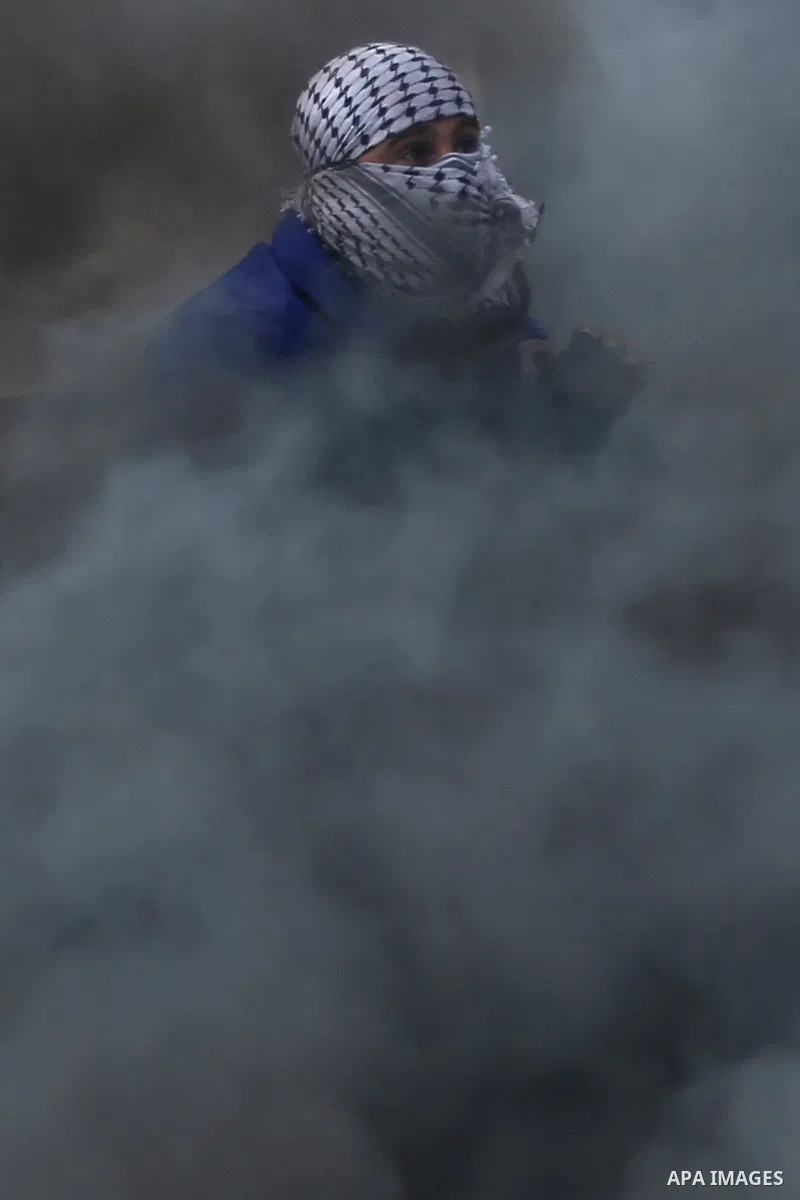 A Palestinian protester uses a sling shot to hurl stones at Israeli troops during clashes near the Jewish settlement of Bet El, near the West Bank city of Ramallah, October 29, 2015. Israeli security forces shot dead two...