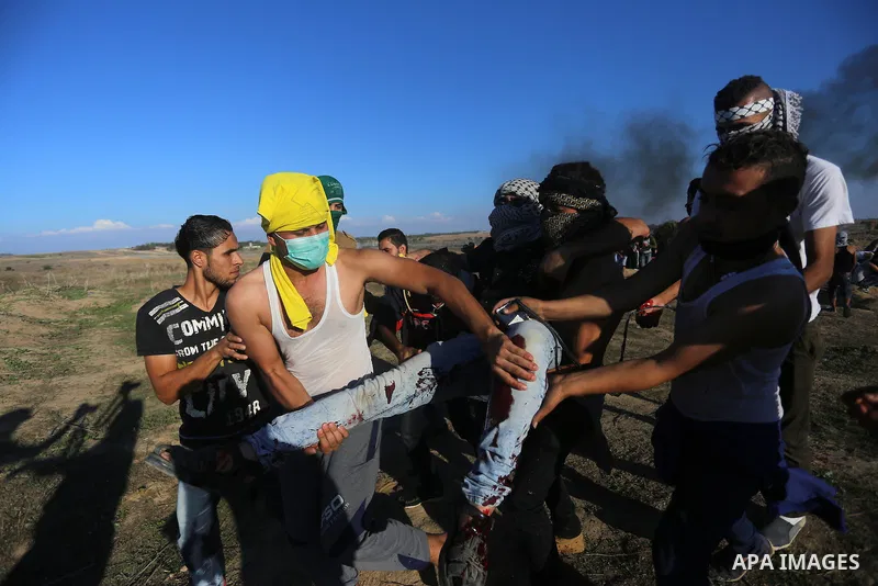 Palestinian protesters take part in clashes with Israeli troops near the border between Israel and central Gaza strip, October 30, 2015. Since the start of October, violence that has included stabbings as well as clashes...
