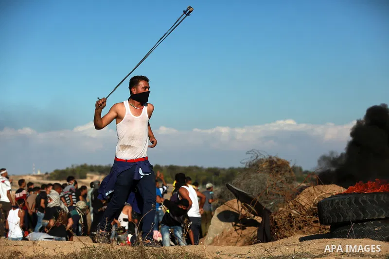 Palestinian protesters take part in clashes with Israeli troops near the border between Israel and central Gaza strip, October 30, 2015. Since the start of October, violence that has included stabbings as well as clashes...