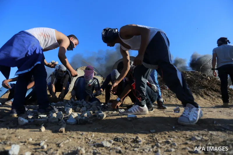 Palestinian protesters take part in clashes with Israeli troops near the border between Israel and central Gaza strip, October 30, 2015. Since the start of October, violence that has included stabbings as well as clashes...