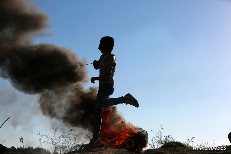 Palestinian protesters take part in clashes with Israeli troops near the border between Israel and central Gaza strip, October 30, 2015. Since the start of October, violence that has included stabbings as well as clashes...