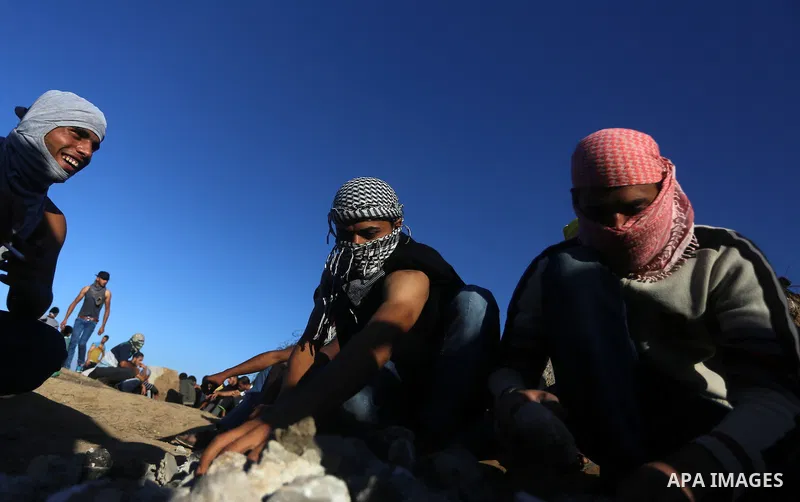 Palestinian protesters take part in clashes with Israeli troops near the border between Israel and central Gaza strip, October 30, 2015. Since the start of October, violence that has included stabbings as well as clashes...