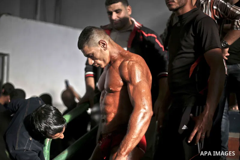 A Palestinian contestant takes part in a local bodybuilding championship in Gaza City October 30, 2015. Photo by Mohammed Talatene