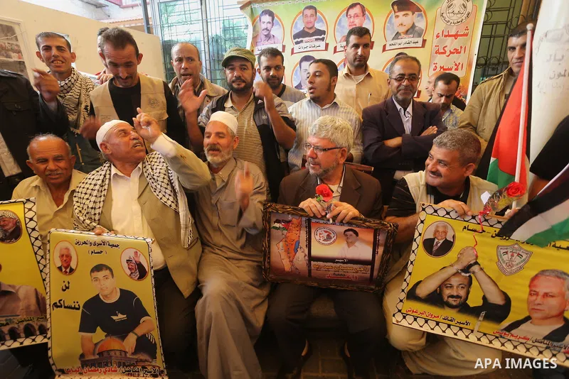 Palestinians take part in a protest demanding release the prisoners in Israeli jails, in front of Red cross office, in Gaza city, on Nov. 02, 2015. Photo by Mohammed Asad