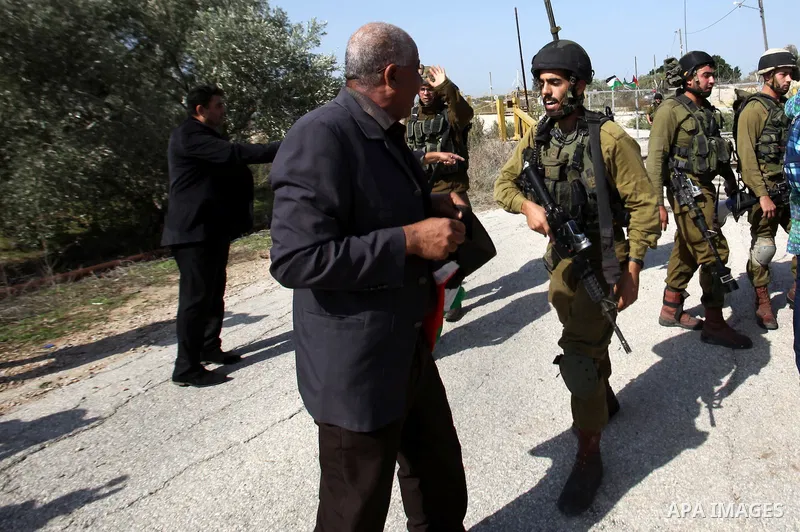 A Palestinian protester argues with Israeli security forces during a demonstration against the expropriation of Palestinian land and the Israeli controversial separation barrier, in the village of Shwaika, near the West...