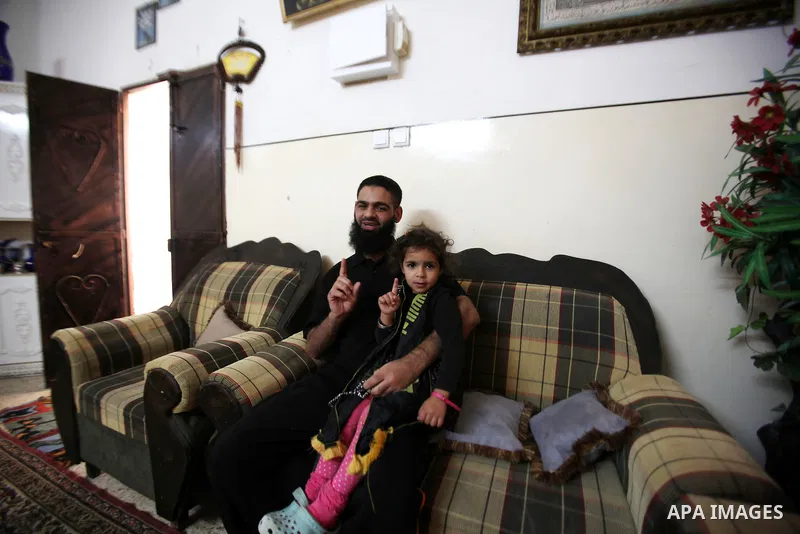 Former Palestinian detainee Mohammed Allan carries his daughter at his house in Nablus in the West Bank on November 5, 2015, after he was released from Israeli jail. Israeli authorities said they had freed Allan, late on...
