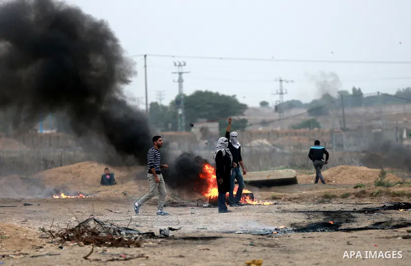 A Palestinian protester uses a big sling shot to throw stones towards Israeli security forces during clashes near the border between Israel and eastern Gaza city, November 6, 2015. The current wave of violence erupted in...