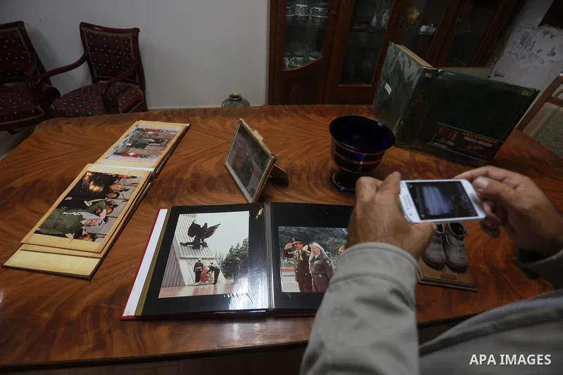A Palestinian woman takes picture of photo album of late Palestinian leader Yasser Arafat at his house, following a meeting between leaders of Hamas and Fatah movements, in Gaza city on November 10, 2011. A Fatah spokesp...