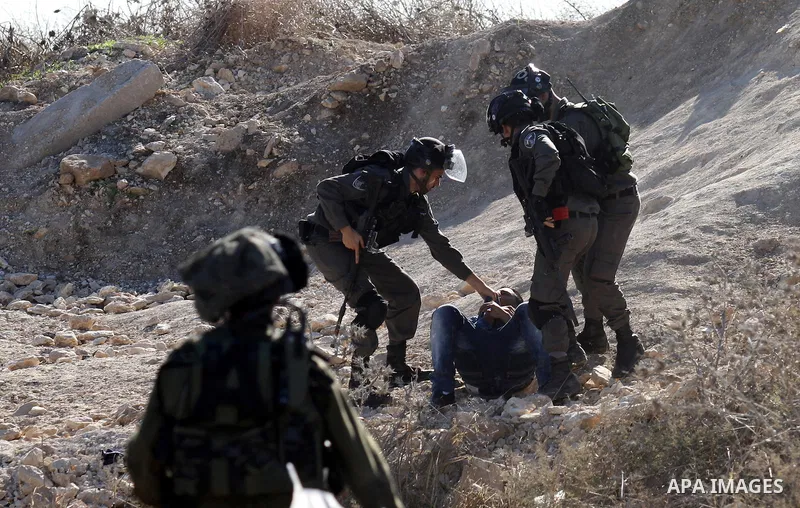 Israeli security forces detain a Palestinian protester during clashes in the West Bank city of Tulkarm November 12, 2015. Israeli undercover forces raided a hospital in the West Bank on Thursday, shooting dead a Palestin...