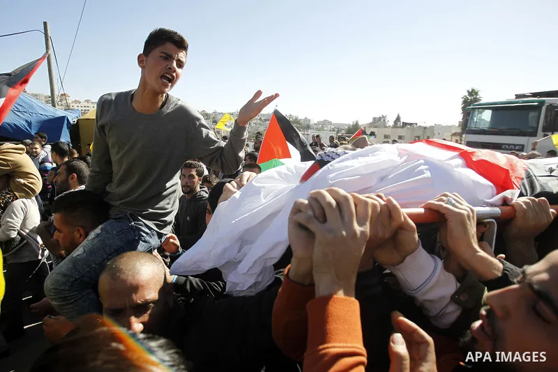 Palestinians carry the body of 23 year old Hassan Al-Baw, who was killed in clashes with Israeli forces, during his funeral in the West Bank village of Halhul, near Hebron, Saturday, Nov. 14, 2015. Photo by Wisam Hashlam...