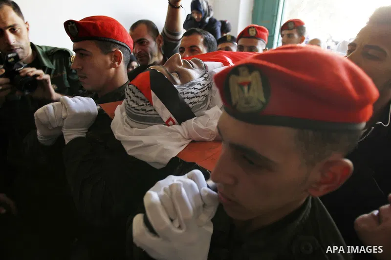 Palestinians carry the body of 23 year old Hassan Al-Baw, who was killed in clashes with Israeli forces, during his funeral in the West Bank village of Halhul, near Hebron, Saturday, Nov. 14, 2015. Photo by Wisam Hashlam...
