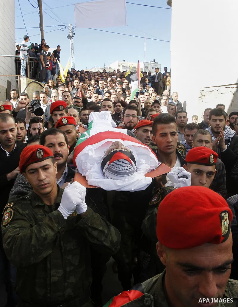 Palestinians carry the body of 23 year old Hassan Al-Baw, who was killed in clashes with Israeli forces, during his funeral in the West Bank village of Halhul, near Hebron, Saturday, Nov. 14, 2015. Photo by Wisam Hashlam...