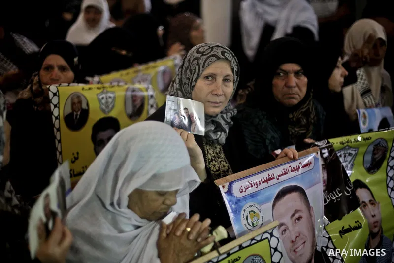 Palestinians take part in a protest demanding release the prisoners in Israeli jails, in front of Red cross office, in Gaza city, on Nov. 16, 2015. Photo by Mohammed Talatene
