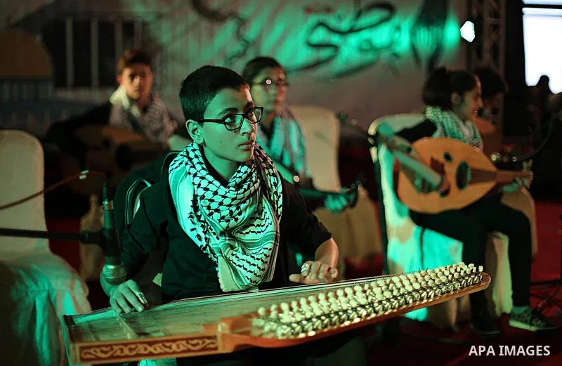 Palestinian youths play music during an event to show solidarity with the Palestinians in the West Bank and Jerusalem, in Gaza city on November 18, 2015. The surge in violence across Israel, Jerusalem and the Israeli-occ...