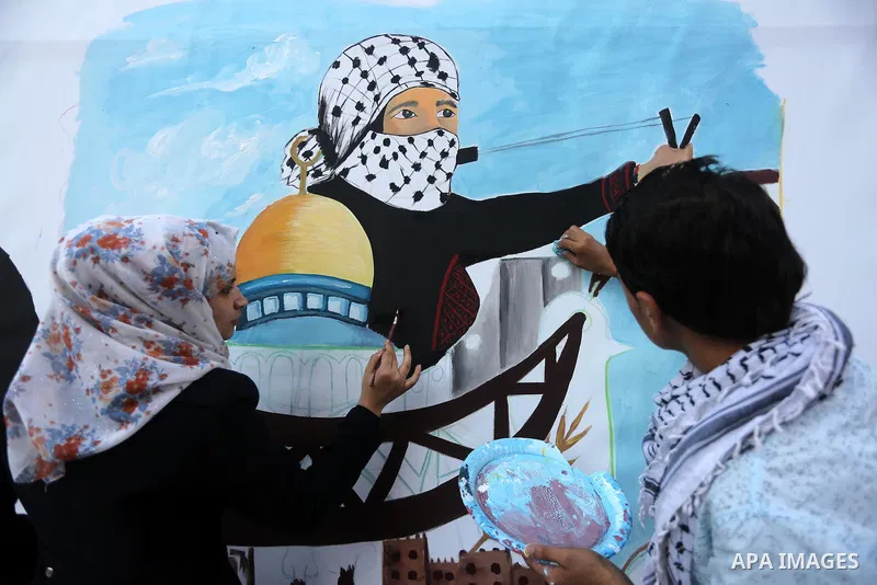 Palestinians paint murals during an event to show solidarity with the Palestinians in the West Bank and Jerusalem, in Gaza city on November 18, 2015. The surge in violence across Israel, Jerusalem and the Israeli-occupie...