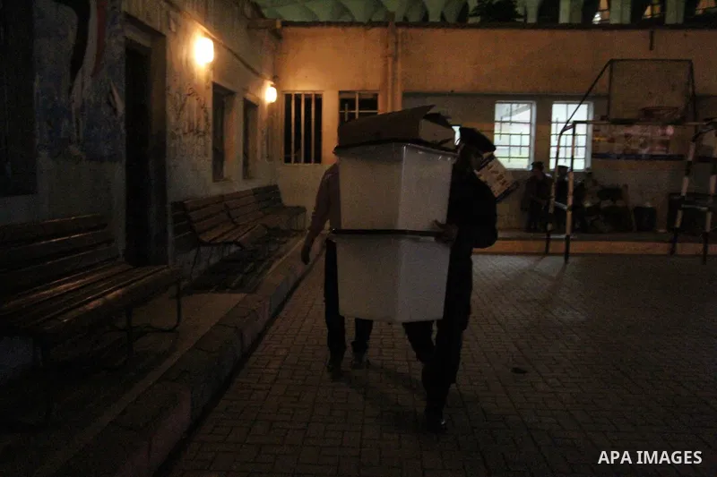 Egyptian officials inspect boxes containing ballot cards during the second round of parliamentary elections at a polling station in Cairo, Egypt, November 22, 2015. Egyptians voted on Sunday in the second phase of electi...