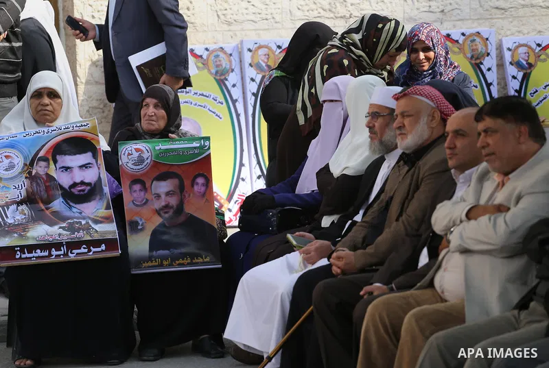 Palestinians take part in a protest demanding release the prisoners in Israeli jails, in front of Red cross office, in Gaza city, on Nov. 23, 2015. Photo by Mohammed Asad