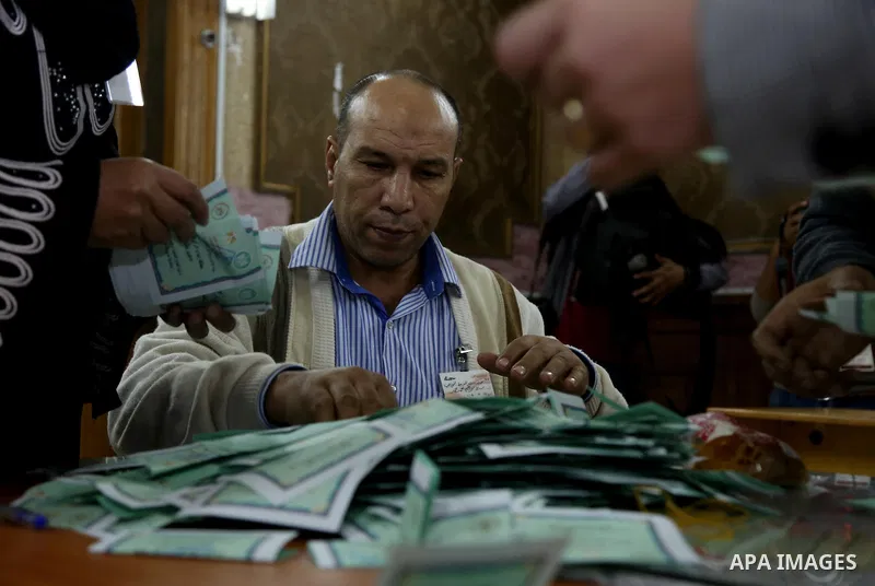 Officials count ballots after polls closed during the second round of parliamentary election in Cairo, Egypt, November 23, 2015. Photo by Amr Sayed