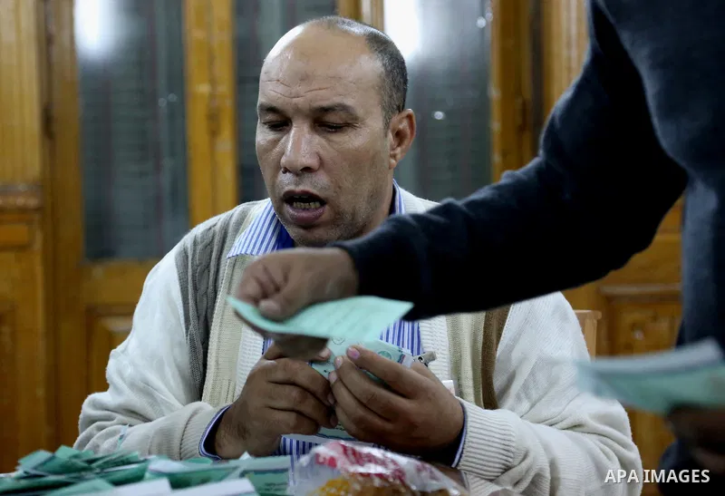 Officials count ballots after polls closed during the second round of parliamentary election in Cairo, Egypt, November 23, 2015. Photo by Amr Sayed