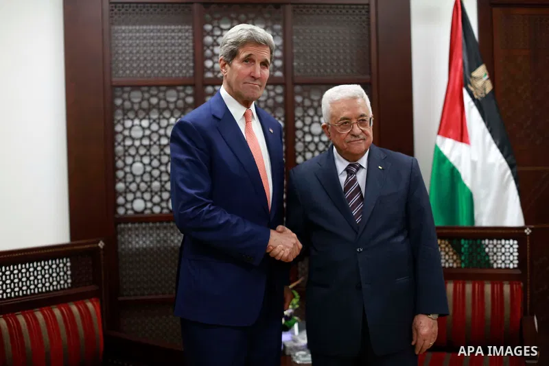 Palestinian President Mahmoud Abbas (R) shakes hands with US Secretary of State John Kerry (L) before their meeting at Abbas's Headquarter in the West Bank city of Ramallah, November 24, 2015. Kerry is on his first visit...