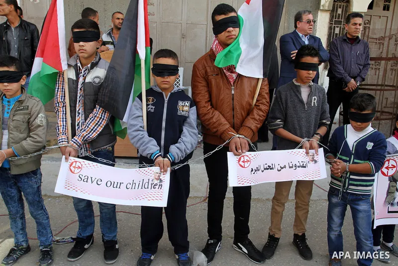 Palestinian supporters of Popular front for Liberation of Palestine (PFLP), take part in a protest in solidarity with jailed Palestinian boy Ahmad Manasrah, in Khan Younis in the southern Gaza Strip, November 26, 2015. T...