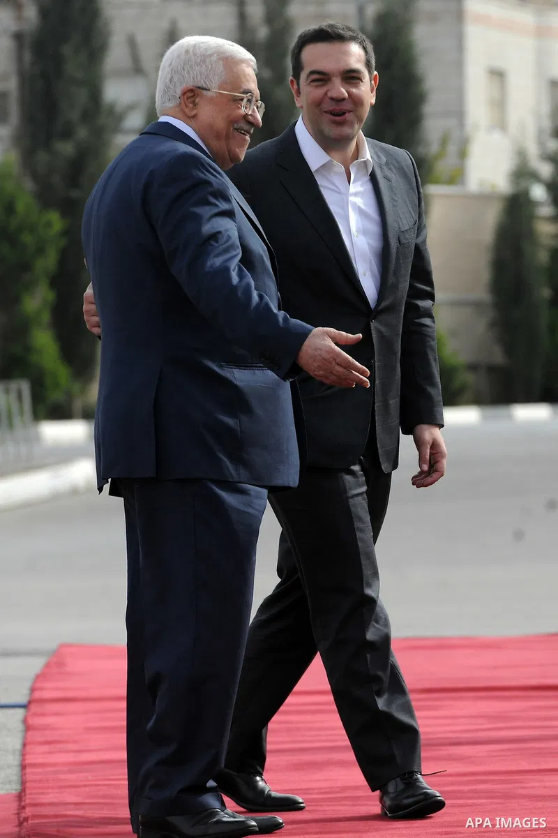 Palestinian President Mahmoud Abbas (L) greets Greek Prime Minister Alexis Tsipras upon Tsipras's arrival at the West Bank city of Ramallah November 26, 2015. Photo by Thaer Ganaim