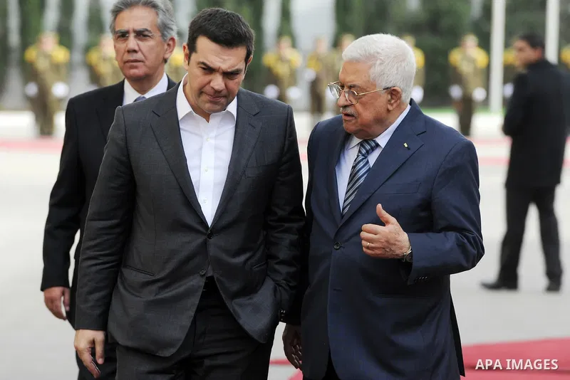 Palestinian President Mahmoud Abbas (R) greets Greek Prime Minister Alexis Tsipras upon Tsipras's arrival at the West Bank city of Ramallah November 26, 2015. Photo by Thaer Ganaim