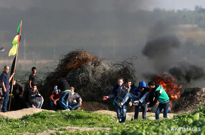 An injured Palestinian protester is evacuated during clashes with Israeli security forces near the border between Israel and the central Gaza Strip, November 27, 2015. The current wave of violence erupted in mid-Septembe...