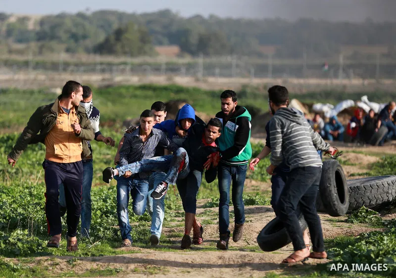 An injured Palestinian protester is evacuated during clashes with Israeli security forces near the border between Israel and the central Gaza Strip, November 27, 2015. The current wave of violence erupted in mid-Septembe...