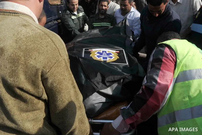 Egyptian police and emergency personnel carry a body on a stretcher at the site where masked gunmen on a motorcycle shot dead four Egyptian policemen south of the capital Cairo, on November 28, 2015. According to the Egy...
