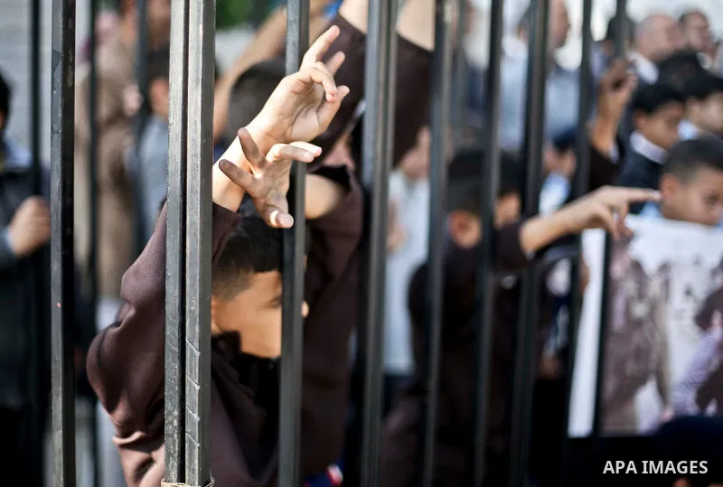 Palestinian children take part in a protest demanding release the prisoners in Israeli jails, in front of high commissioner for human rights headquarters, in Gaza city, on November 29, 2015. Photo by Mohammed Talatene