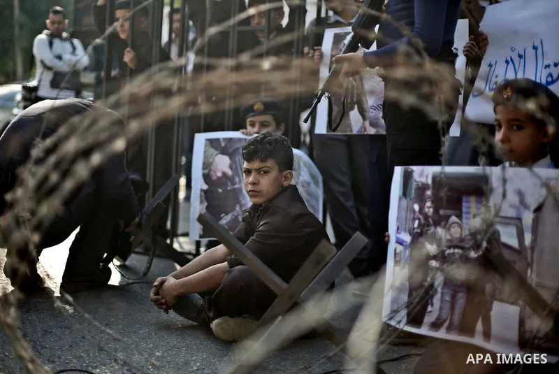 Palestinian children take part in a protest demanding release the prisoners in Israeli jails, in front of high commissioner for human rights headquarters, in Gaza city, on November 29, 2015. Photo by Mohammed Talatene
